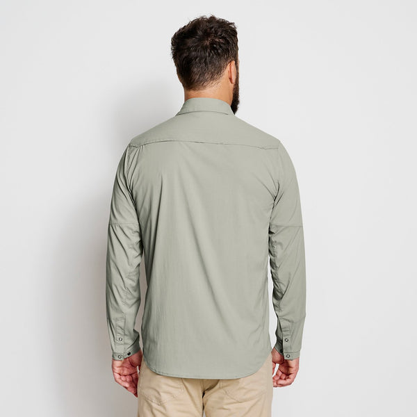 man with his back to the camera wearing light green shirt
