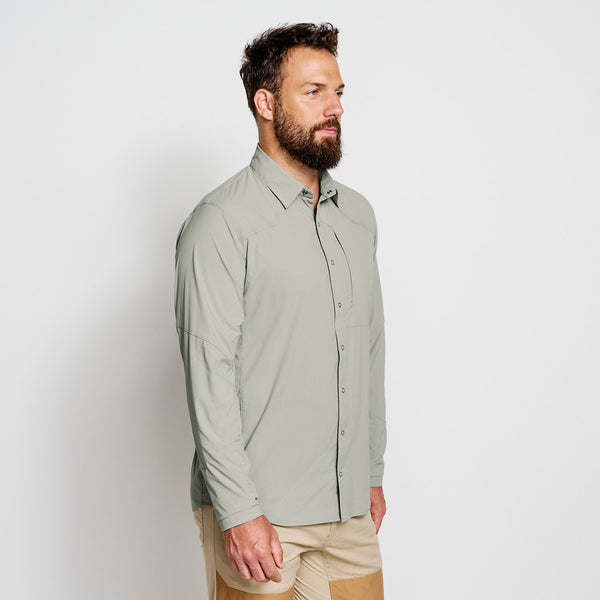 man wearing green shirt in front of white background