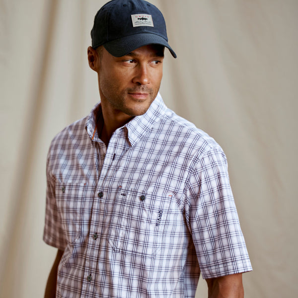 Man wearing white and black shirt and cap