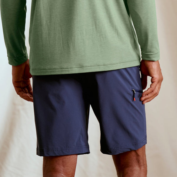 closeup of back of man wearing blue short and green jumper