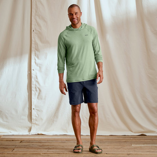 man waering green jumper and blue shorts facing camera