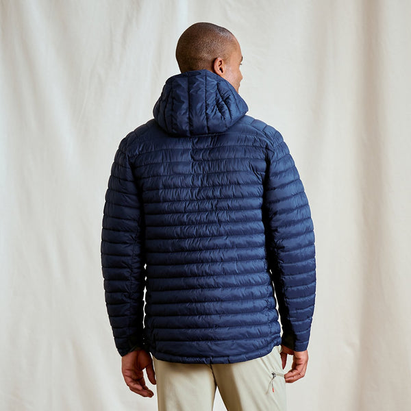 man wearing dark blue jacket facing away from camera