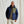 Load image into Gallery viewer, man smiling to camera wearing blue jacket in front of green background
