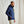 Load image into Gallery viewer, man wearing dark blue jacket and beige pants in front of beige background

