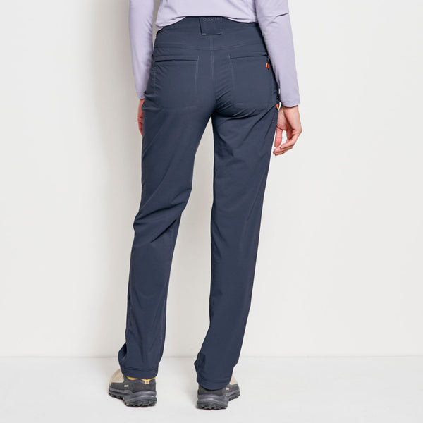 woman facing away from the camera wearing dark blue pants