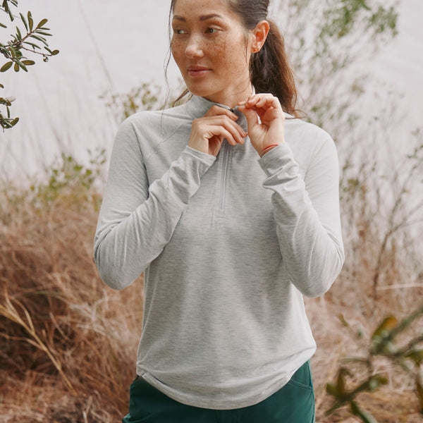 woman wearing light grey half zipper sweater