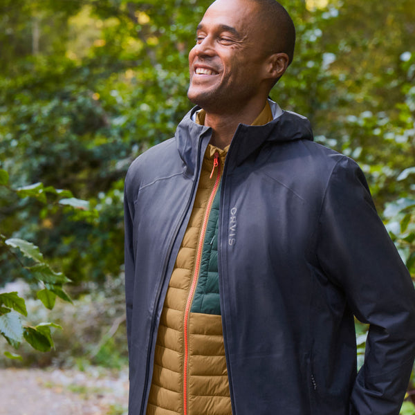 man smiling wearing dark blue waterproof jacket