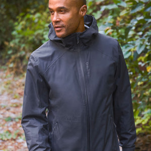 man in the woods wearing dark blue jacket
