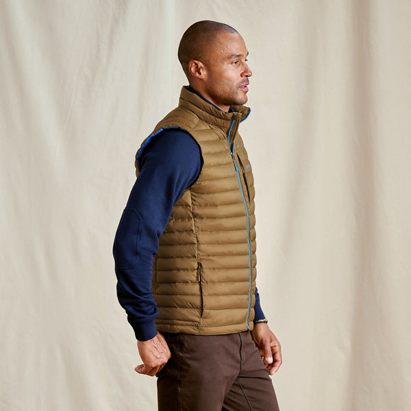 man wearing blue jumper and beige vest