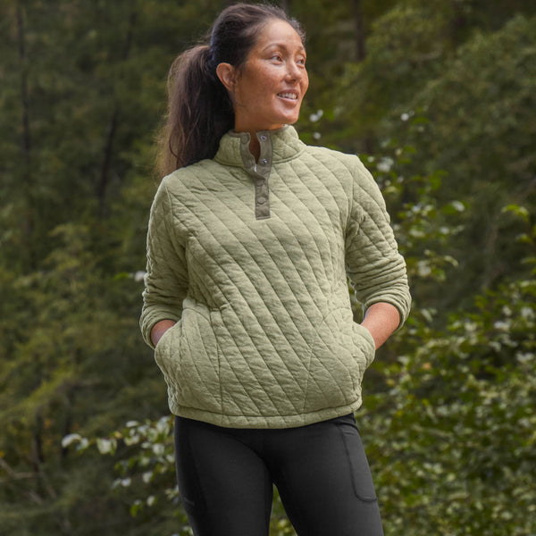 woman modellling green sweater and black tights