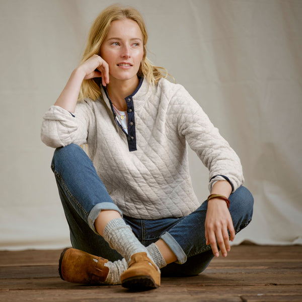 woman seated on wooden floor
