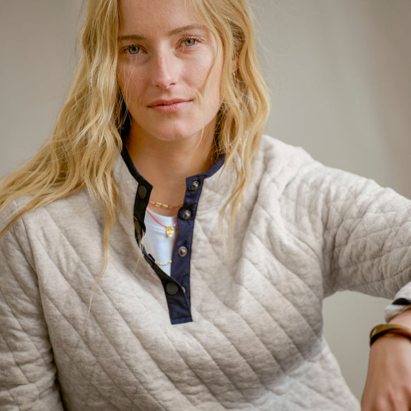 blong woman wearing grey sweater
