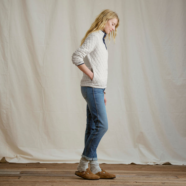 woman modelling white sweater and jeans