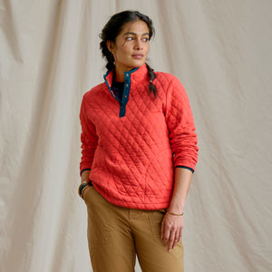woman showing red sweater and beige pants