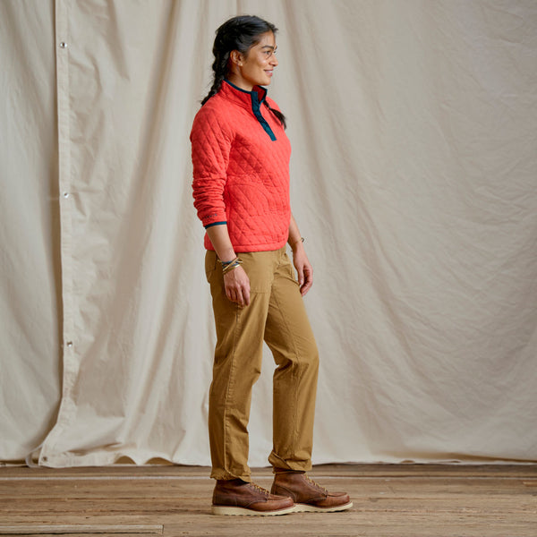 woman modelling red sweater and beige pants