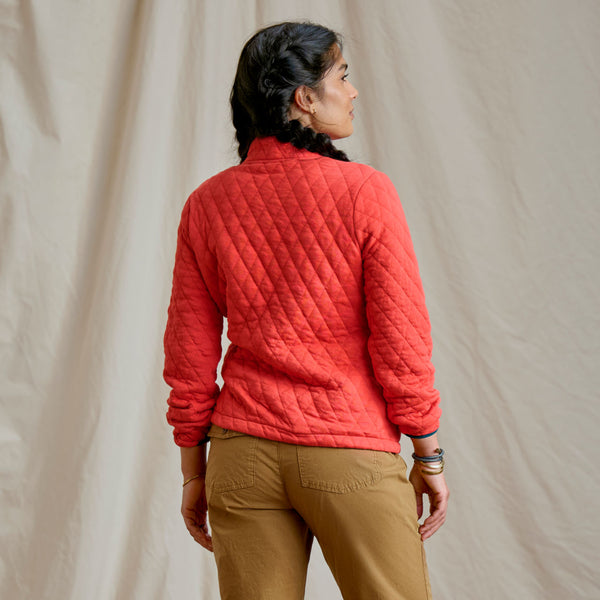 woman modelling red sweaster and beige pants