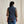 Load image into Gallery viewer, Person wearing a navy vest over a plaid shirt with a beige background
