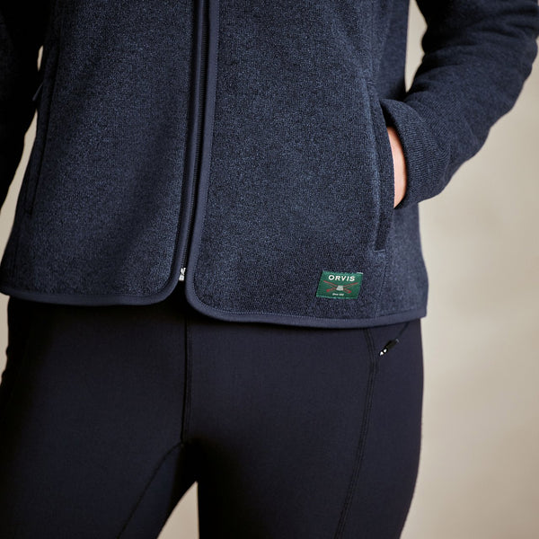 Navy blue jacket with a visible brand logo on a neutral background