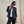 Load image into Gallery viewer, Person wearing a navy jacket, white shirt, and black pants with a matching cap on a beige background
