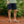 Load image into Gallery viewer, lower body of man wearing blue shorts and green sandals
