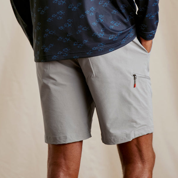man facing away from camera wearing grey shorts