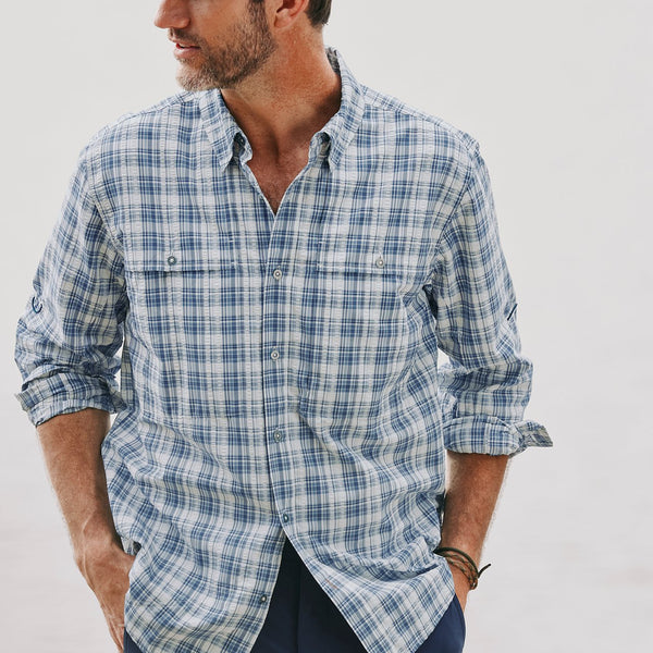 man wearing blue and white checkered shirt looking to the side