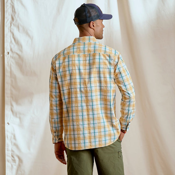 man with back to camera wearing checkered shirt and blue cap