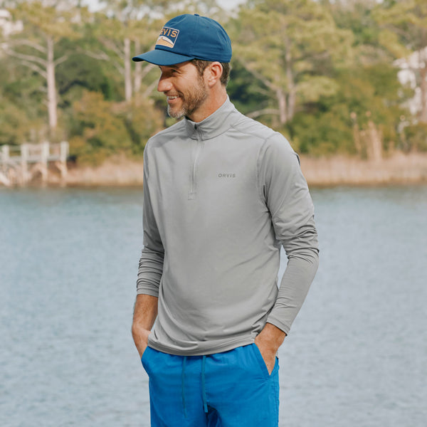 man standing in front of lake wearing outfit from Orvis