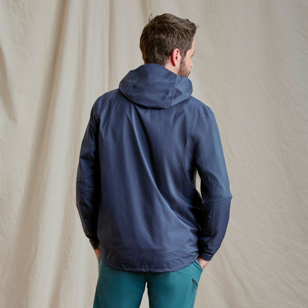 man wearing dark blue jacket facing away from camera
