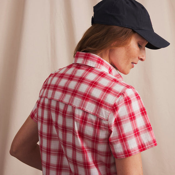 woman wearing lack cap and red and white shirt
