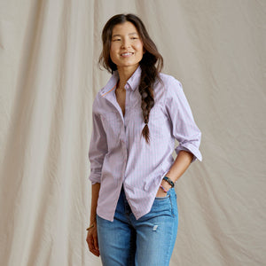 woman facing camera wearing light pink shirt
