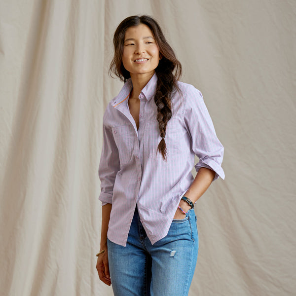 woman facing camera wearing light pink shirt