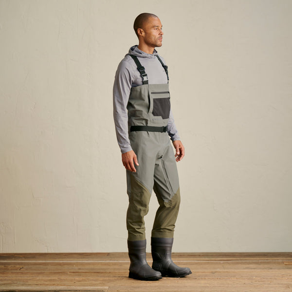 man wearing grey hoodie and grey waders