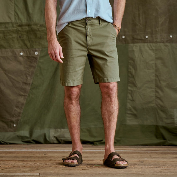 man showing dark green shorts