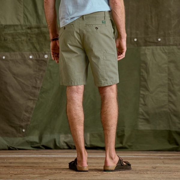 man with back to camera wearing dark green shorts