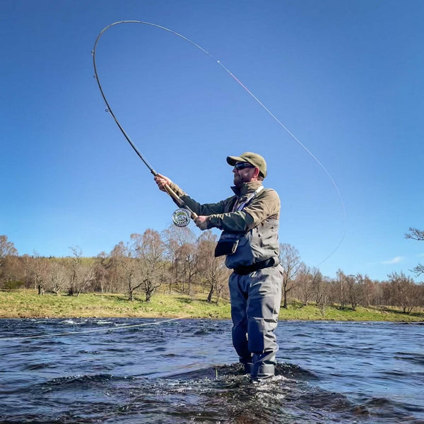 man casting in river