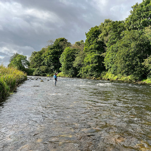 man fly fishing in river