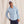 Load image into Gallery viewer, man smiling to camera wearing light blue waterproof jacket and cap with fish logo
