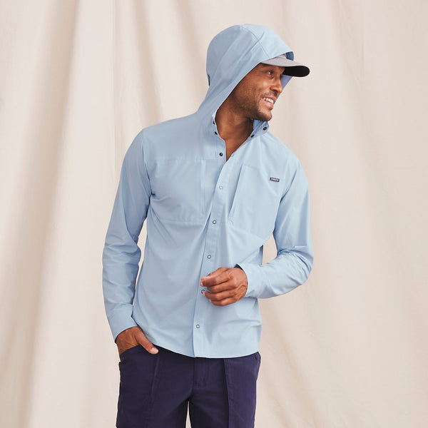 man wearing light blue waterproof jacket