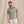 Load image into Gallery viewer, man smiling waering green poloshirt and white trousers
