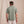 Load image into Gallery viewer, man with his back to the camera wearing green polo shirt and white trousers
