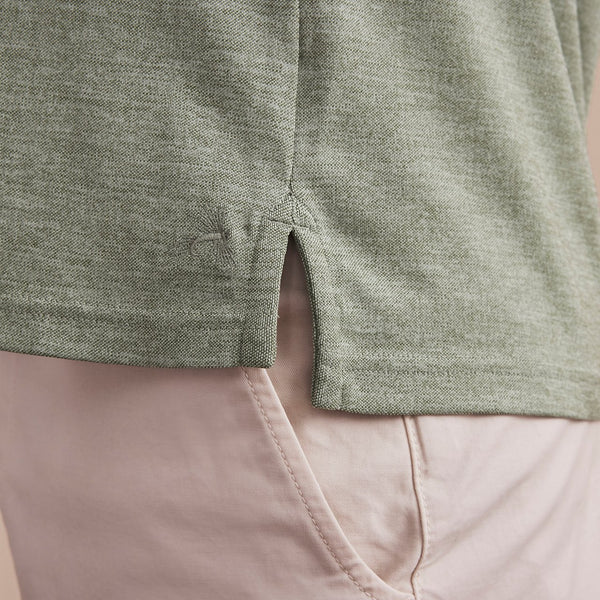closeup of side of green poloshirt