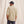 Load image into Gallery viewer, man with his back to the camera in front of beige background
