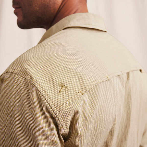 closeup of shoulder and back of man wearing beige shirt