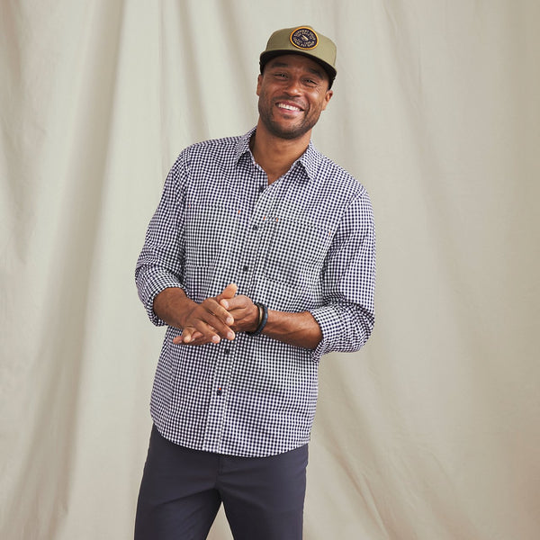 man smiling to camera wearing green cap