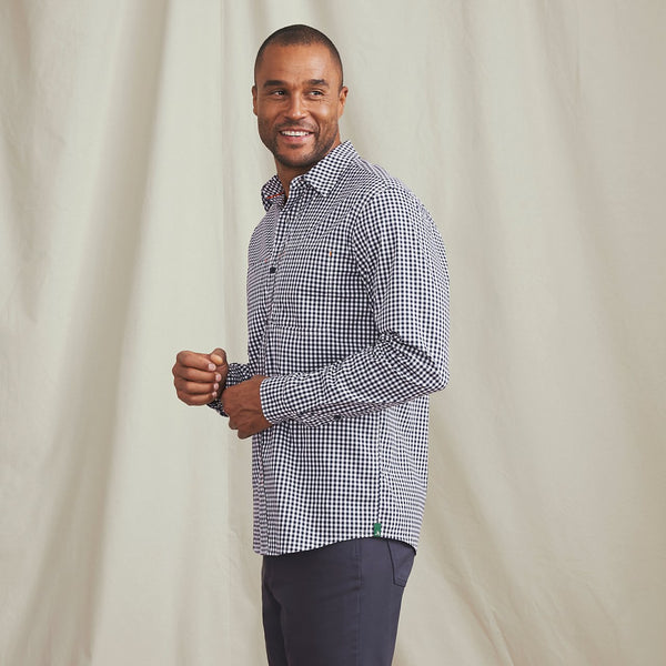 man smiling wearing checkered shirt