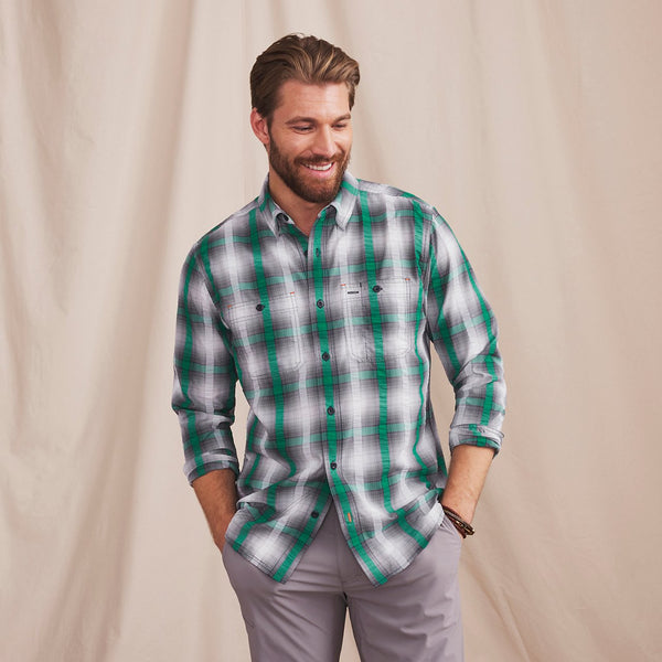 man smiling wearing green and black shirt