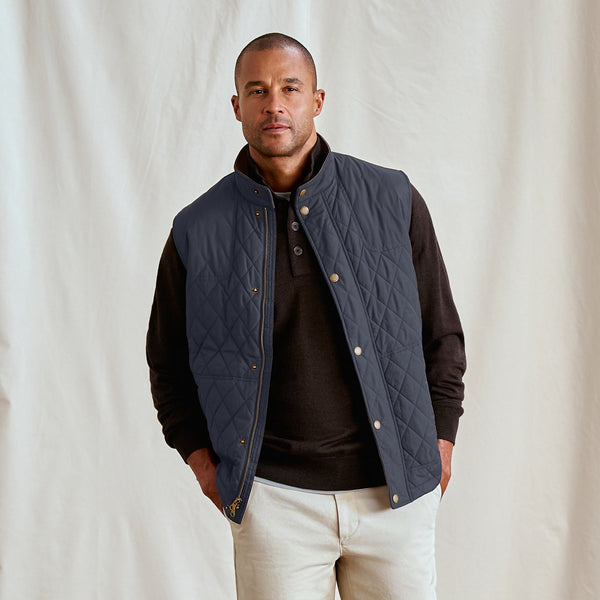 man wearing blue vest and white pants