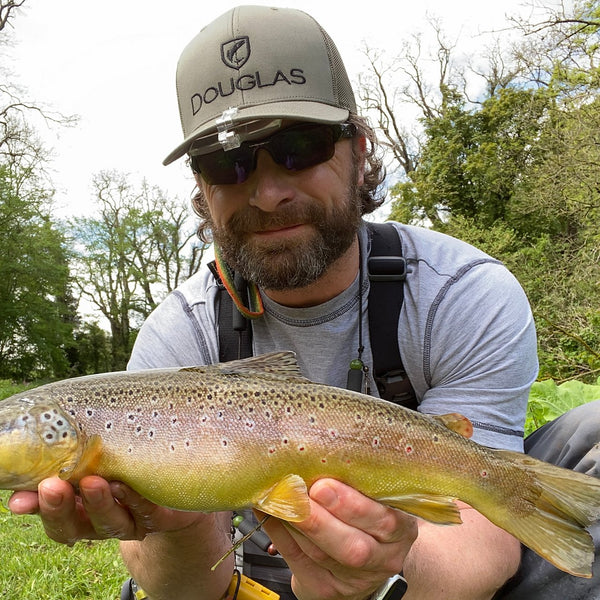 man showing fish to the camera