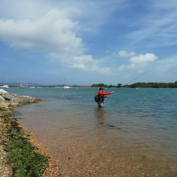 man wading in river